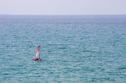 Red Sailboat On Large Ocean