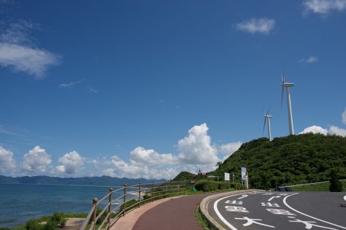 road blue sky wind turbine
