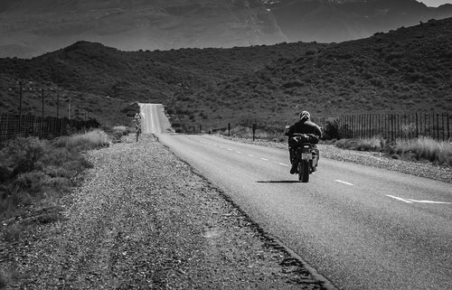 road  black white  motorcyclist