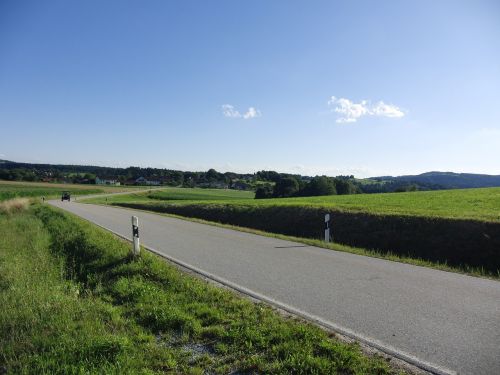 road blue sky partly cloudy