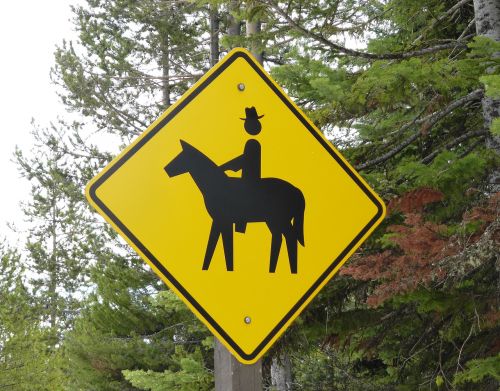 road sign horseback riding head