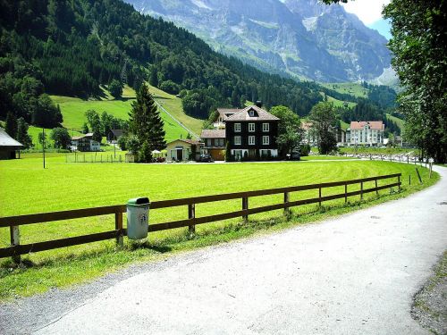 road through village house in mountains swiss