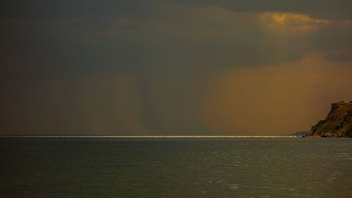 rock sea clouds