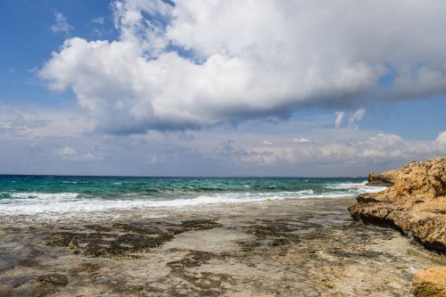 rocky coast sky clouds