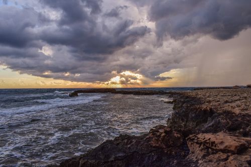 rocky coast sky clouds