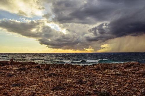 rocky coast sky clouds