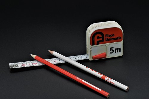 rolling meter  tape measure  pencil