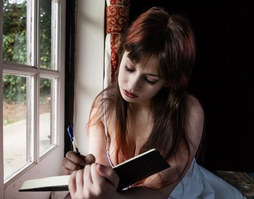 sad woman writing diary
