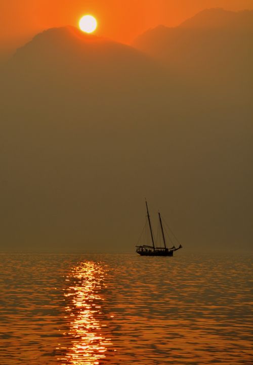 sailing ship lake sunset