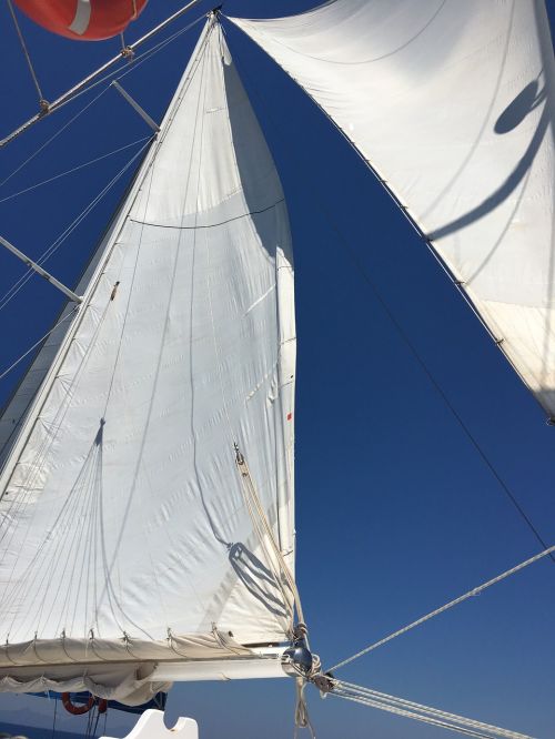 sails blue sky sailing
