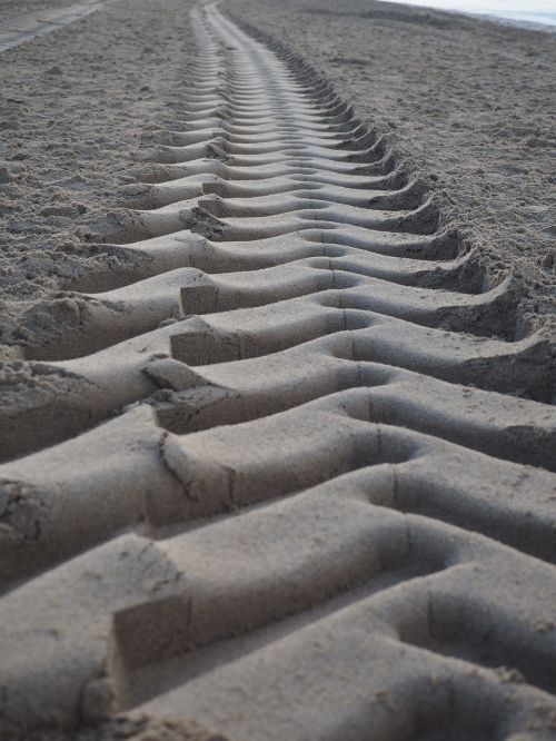 sand traces tire tracks