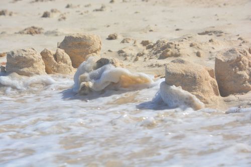 sand castle devastation waves