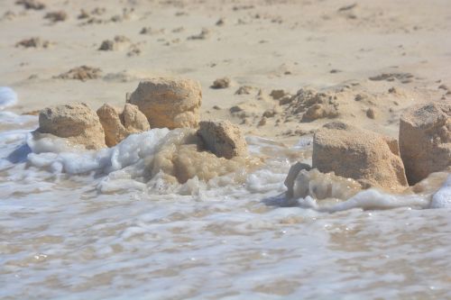 sand castle devastation waves