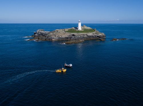 sea lighthouse fishing boats