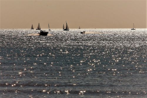 sea boats sunset