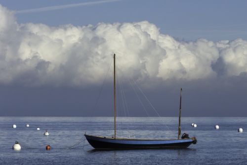 sea boat buoys clouds