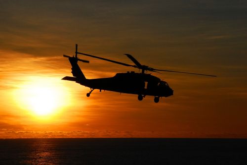 sea hawk helicopter flying sunset