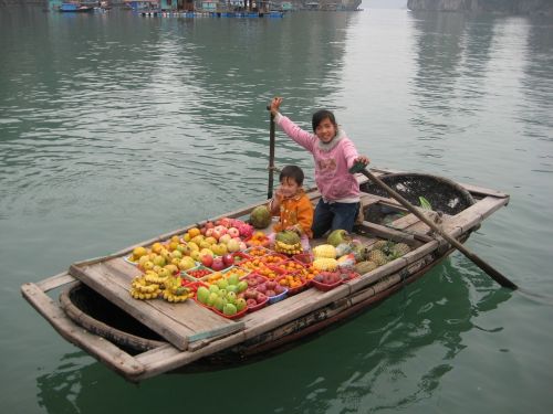 selling fruit fishing village boat