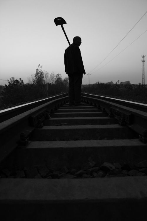 silhouette the train tracks farmer