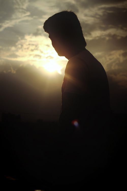 silhouette man sun evening
