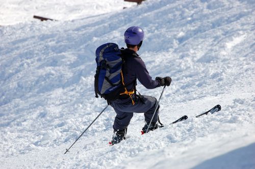 skiers snow backpack