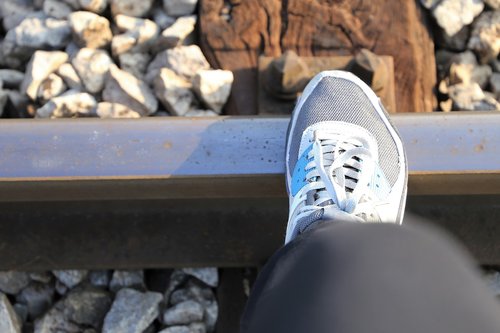 sneaker on railway  rocks  stones