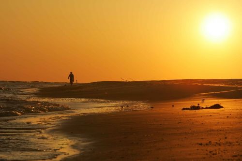 solitary beach person sunset sea