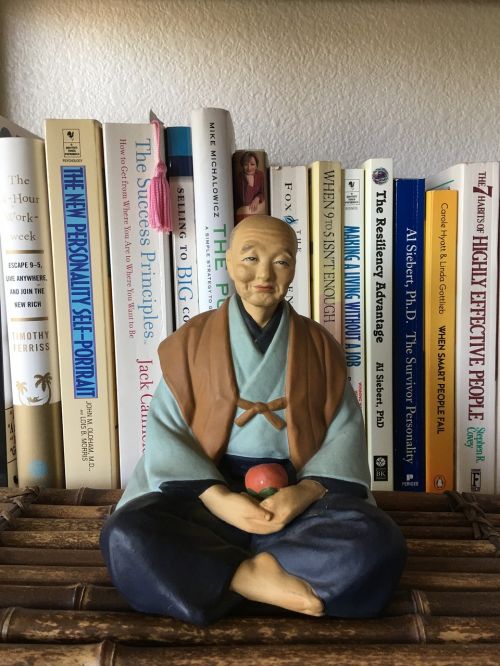 statue asian man meditative pose