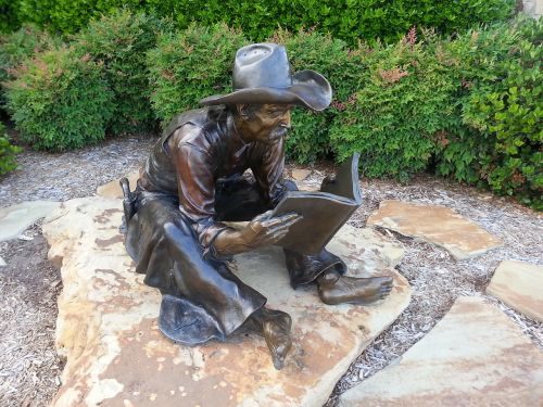 statue cowboy reading