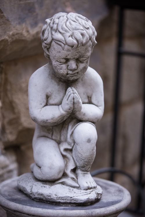 Statue Of Praying Boy