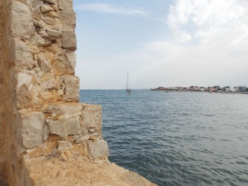 stone wall sea blue sky