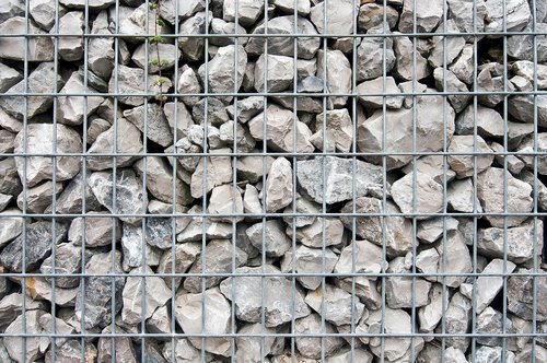 stones  behind bars  grid