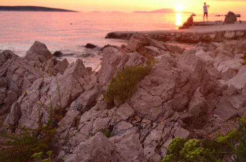 stones sunrise sea