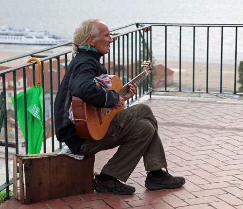 street musician guitar player sit