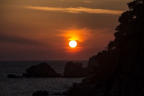 sundown sea mountains