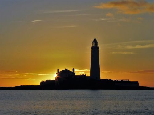 sunrise lighthouse sea