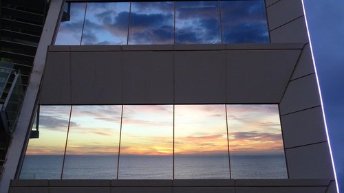 sunrise reflection crystals  sea  building