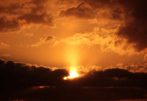 sunset sun dark clouds