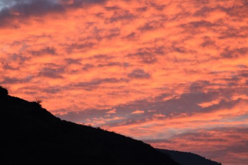 sunset burning clouds mountain