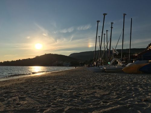 sunset beach sailing boats