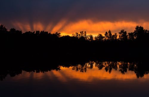 sunset mirroring water