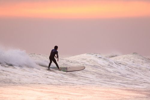 sunset surfer surfing