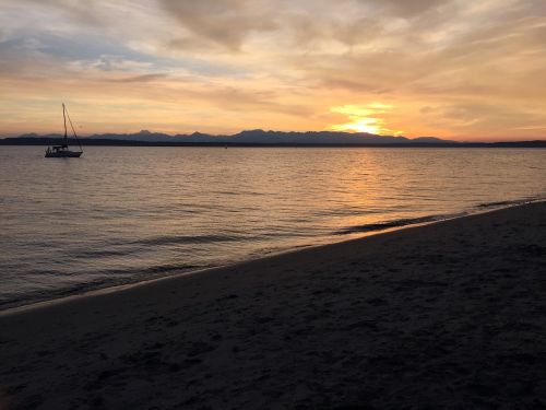 sunset sailboat beach