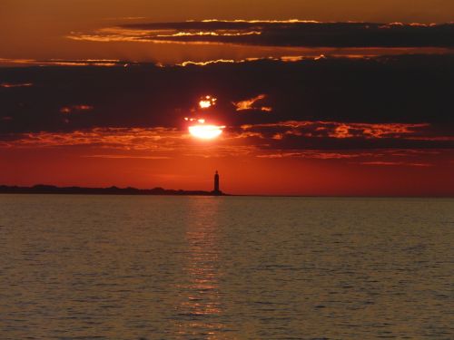 sunset lighthouse sea