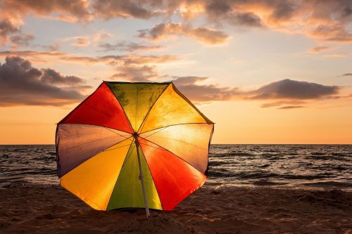 sunset beach umbrella ocean