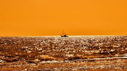 sunset fishing boat shadow