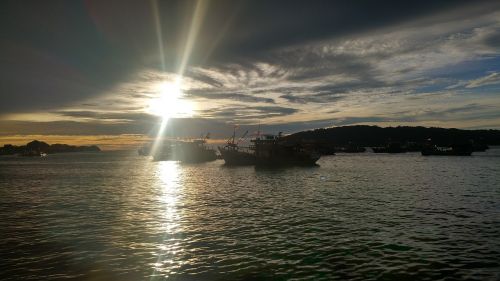 sunset sea fishing boats