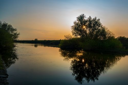 sunset mirroring water