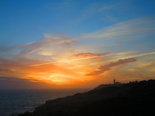 sunset lighthouse coast
