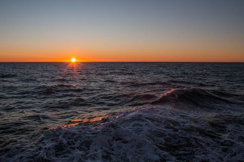 sunset waters sea